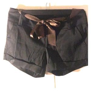 Black shorts with bronze ribbon for a belt